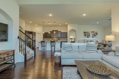 a living room with furniture and a wooden floor