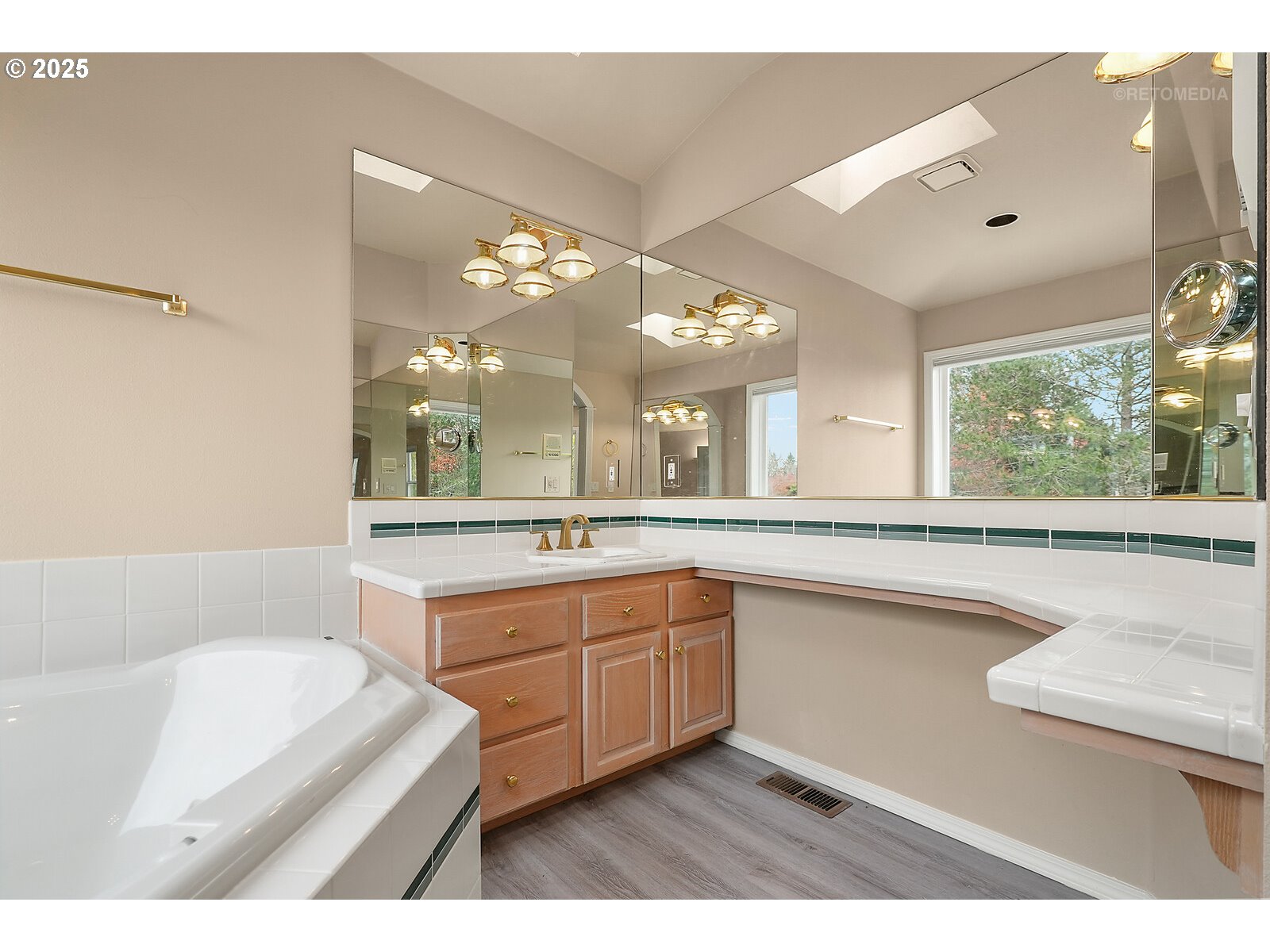 2525 Northwest 141st Place Portland, OR 97229 - Photo 32 of 48 a bathroom with a sink a large mirror and a bathtub