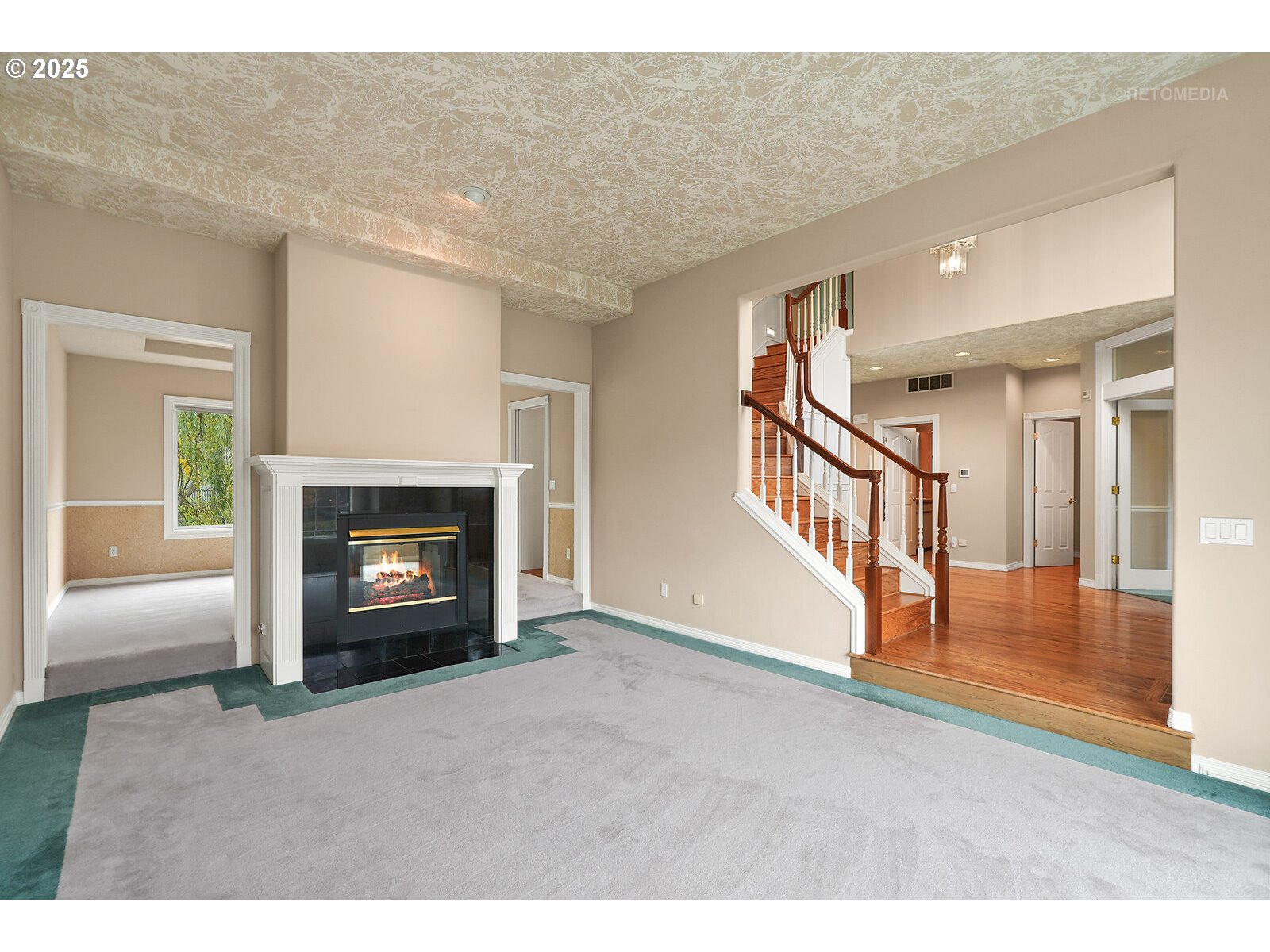 2525 Northwest 141st Place Portland, OR 97229 - Photo 5 of 48 a view of empty room with wooden floor and fireplace