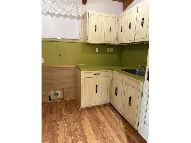 a view of a kitchen with sink and cabinets
