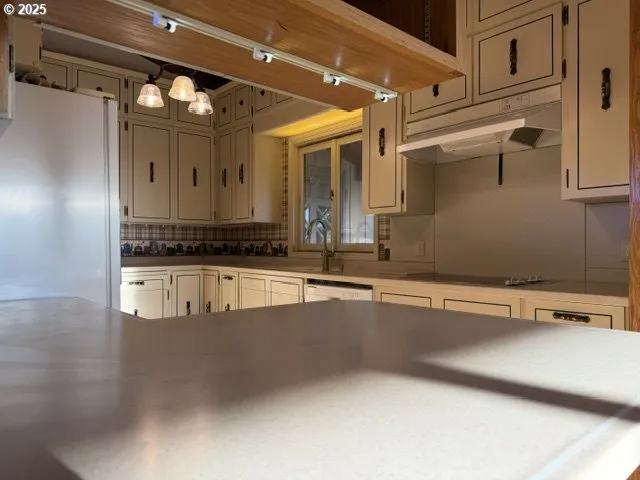 a view of a kitchen with stainless steel appliances granite countertop a sink and a stove