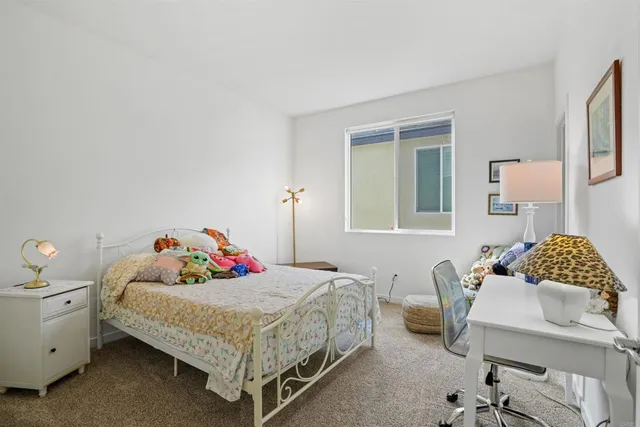 a spacious bedroom with a bed and a chandelier