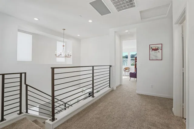 a kitchen with a dining table chairs and white appliances