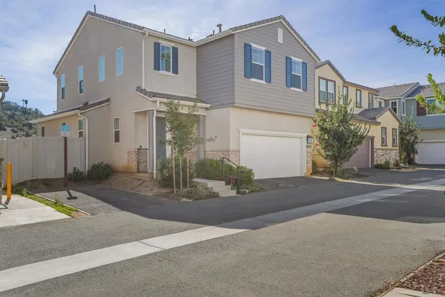 an aerial view of a house with a mountain