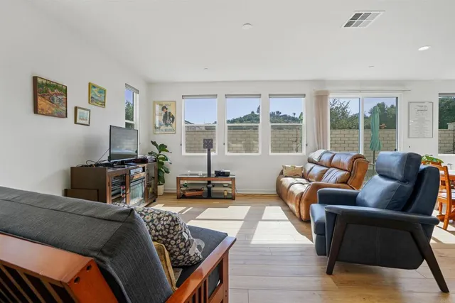a living room with furniture and a floor to ceiling window