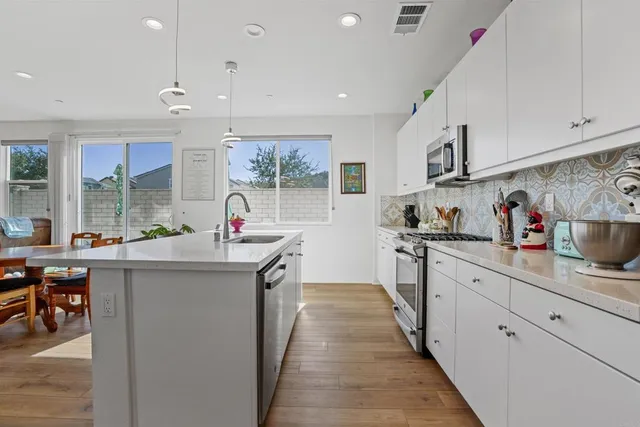 a kitchen with stainless steel appliances granite countertop a sink and cabinets