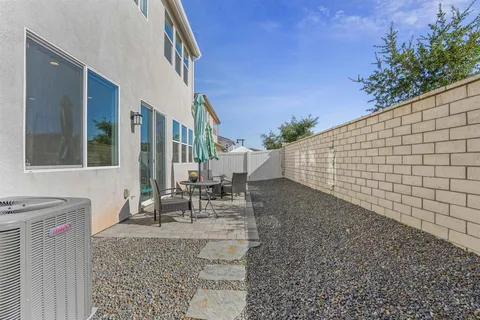 a view of a house with backyard and sitting area