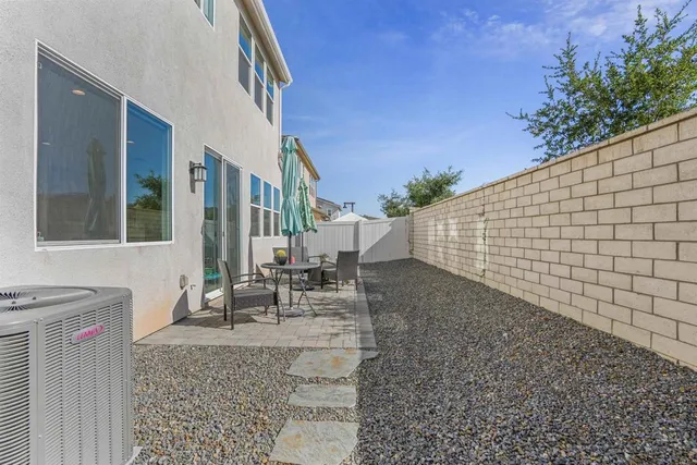 a view of a house with backyard and sitting area