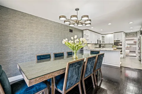 a view of a dining room with furniture and chandelier