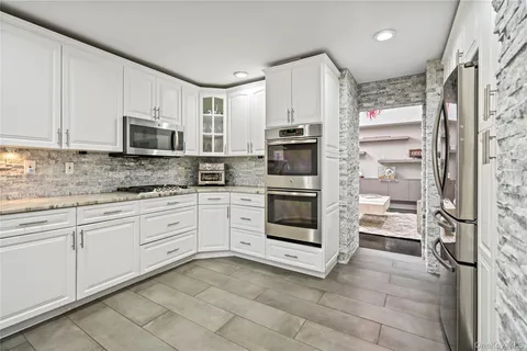 a kitchen with stainless steel appliances a stove sink and microwave