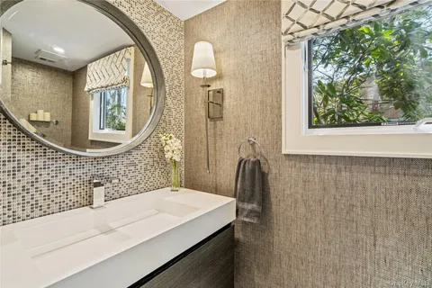 a bathroom with a sink a mirror and a shower
