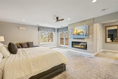a bedroom with a bed and a fireplace
