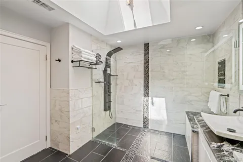a bathroom with a shower and a sink