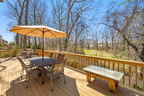 a view of balcony with wooden floor and outdoor seating