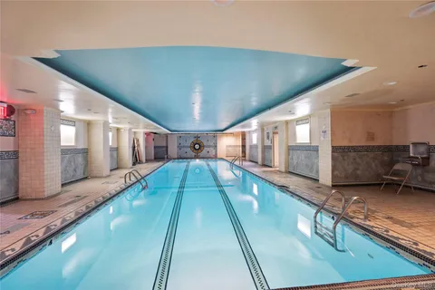 a swimming pool with a large window and outdoor view
