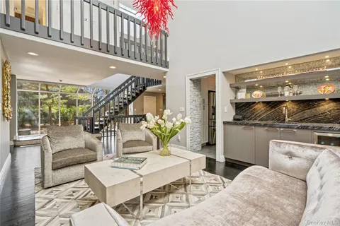 a living room with a couch and a potted plant