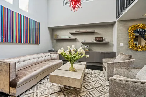 a living room with furniture flowerpot and wooden floor