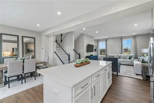 a kitchen with stainless steel appliances a stove a sink a microwave a refrigerator and cabinets