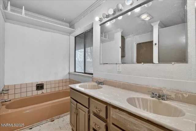 a bathroom with a tub a sink and mirror