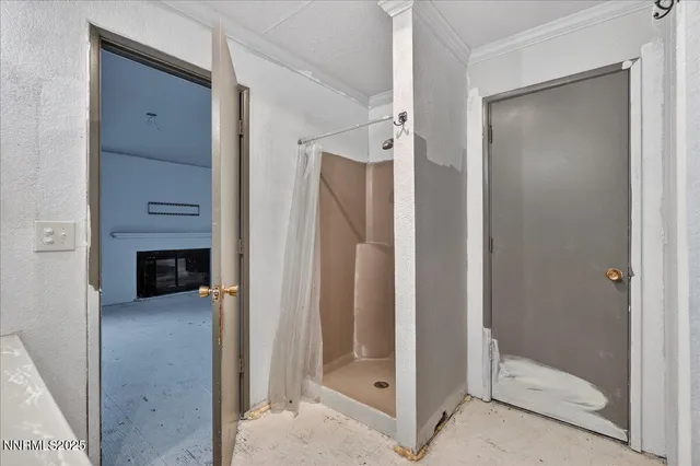 a view of a walk in closet and a bathroom