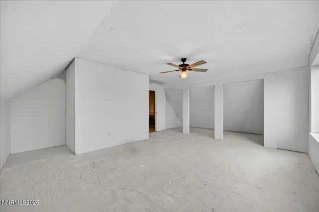 a view of an empty room with a ceiling fan