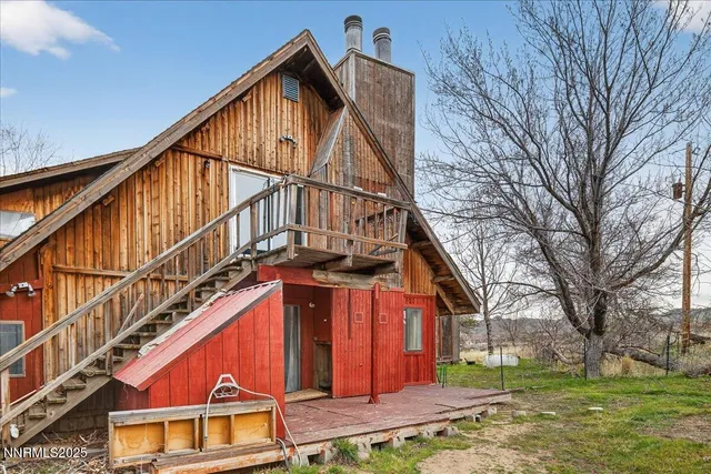 a view of building with yard and sitting area
