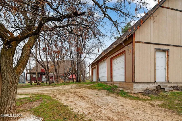 a view of a yard with a house and a tree