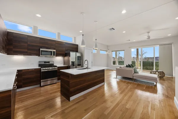 a large kitchen with stainless steel appliances kitchen island granite countertop a large counter top stainless steel appliances and cabinets