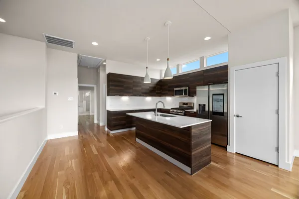 a kitchen with stainless steel appliances granite countertop a stove and a refrigerator