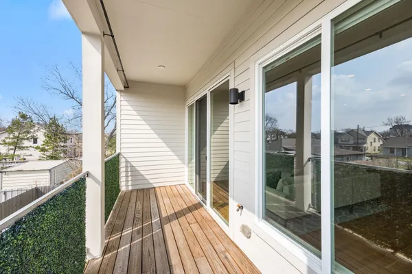 a view of a balcony with wooden floor