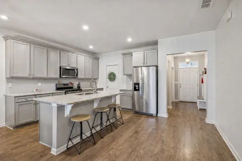a kitchen with cabinets and stainless steel appliances