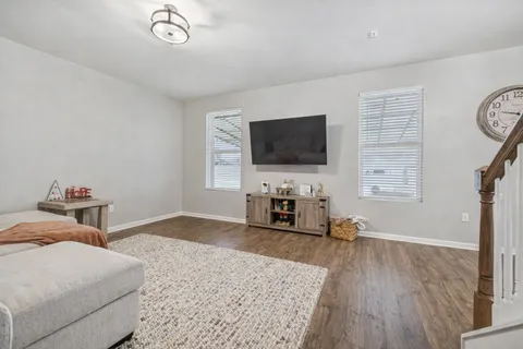 a bedroom with furniture and a flat screen tv