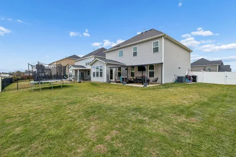 a view of a house with a big yard and sitting area