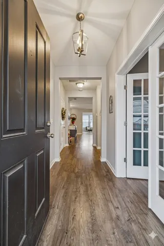 a view of a hallway view with wooden floor and staircase