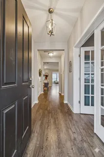 a view of a hallway view with wooden floor and staircase