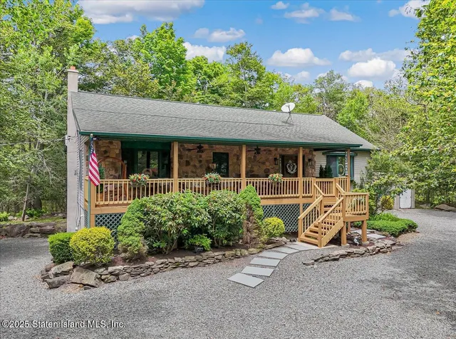a view of a house with backyard and deck