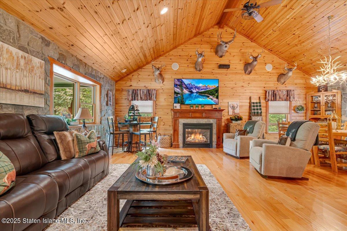 134 Split Rock Road Dingmans Ferry, PA 18328 - Photo 12 of 84 a living room with furniture a fireplace and a flat screen tv