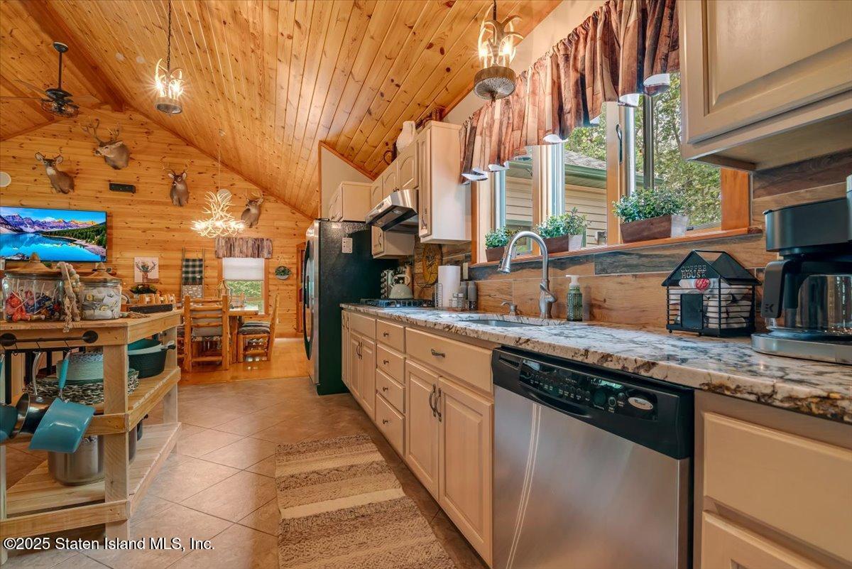 134 Split Rock Road Dingmans Ferry, PA 18328 - Photo 20 of 84 a kitchen with stainless steel appliances granite countertop a sink and cabinets