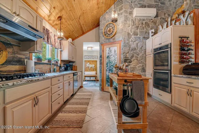 a bedroom with a bed a couch and dresser