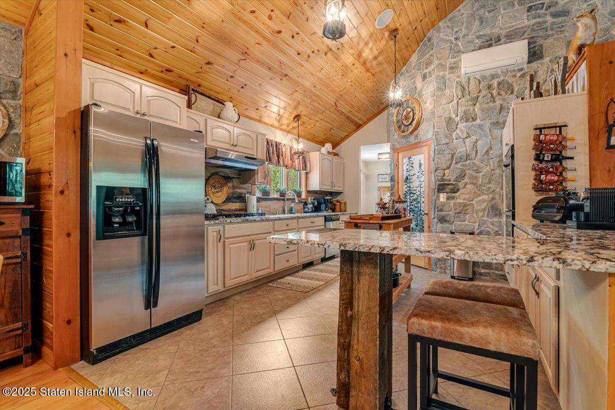 134 Split Rock Road Dingmans Ferry, PA 18328 - Photo 24 of 84 a kitchen with stainless steel appliances granite countertop a sink and cabinets