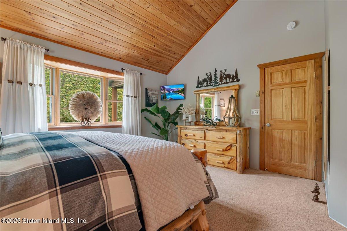 134 Split Rock Road Dingmans Ferry, PA 18328 - Photo 32 of 84 a bedroom with a bed and a large window with the outer view