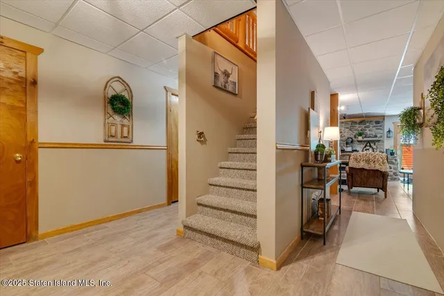 a view of a house with wooden deck and furniture