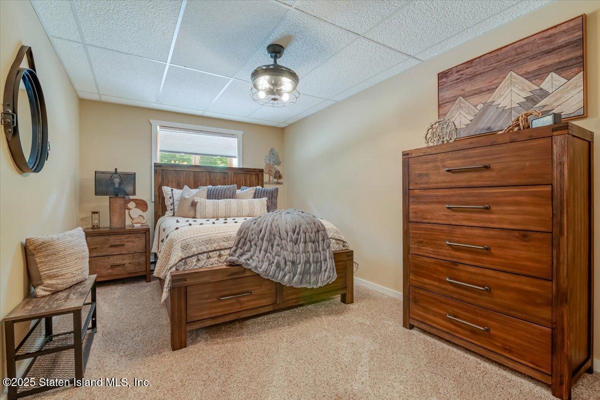 134 Split Rock Road Dingmans Ferry, PA 18328 - Photo 41 of 84 a bedroom with a bed a couch and dresser