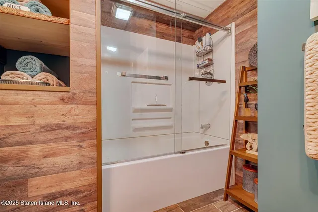 an aerial view of a house with a yard and a large tree
