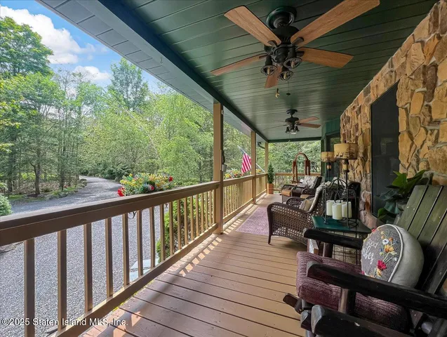 a view of a livingroom with furniture and a floor to ceiling window