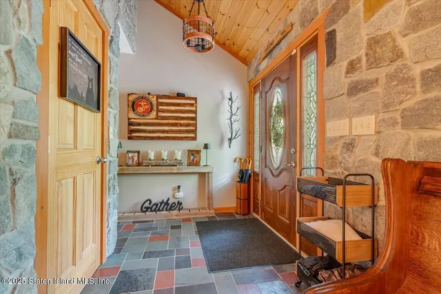 a living room with furniture a fireplace and a large window