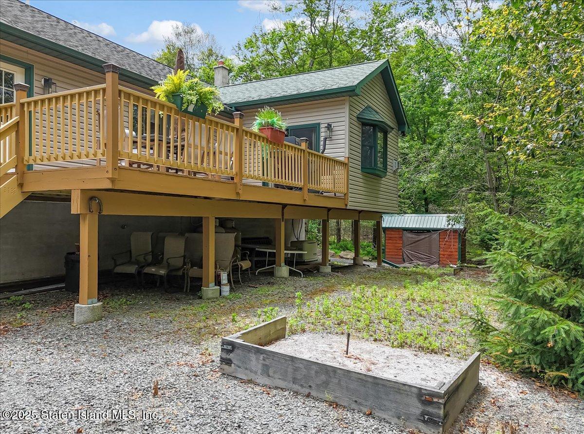 134 Split Rock Road Dingmans Ferry, PA 18328 - Photo 63 of 84 a backyard of a house with barbeque oven table and chairs