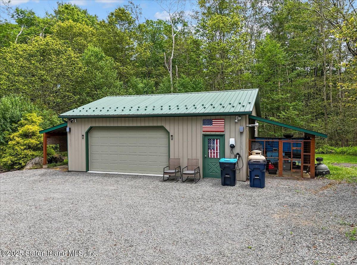 134 Split Rock Road Dingmans Ferry, PA 18328 - Photo 65 of 84 a view of a house with a patio and a yard