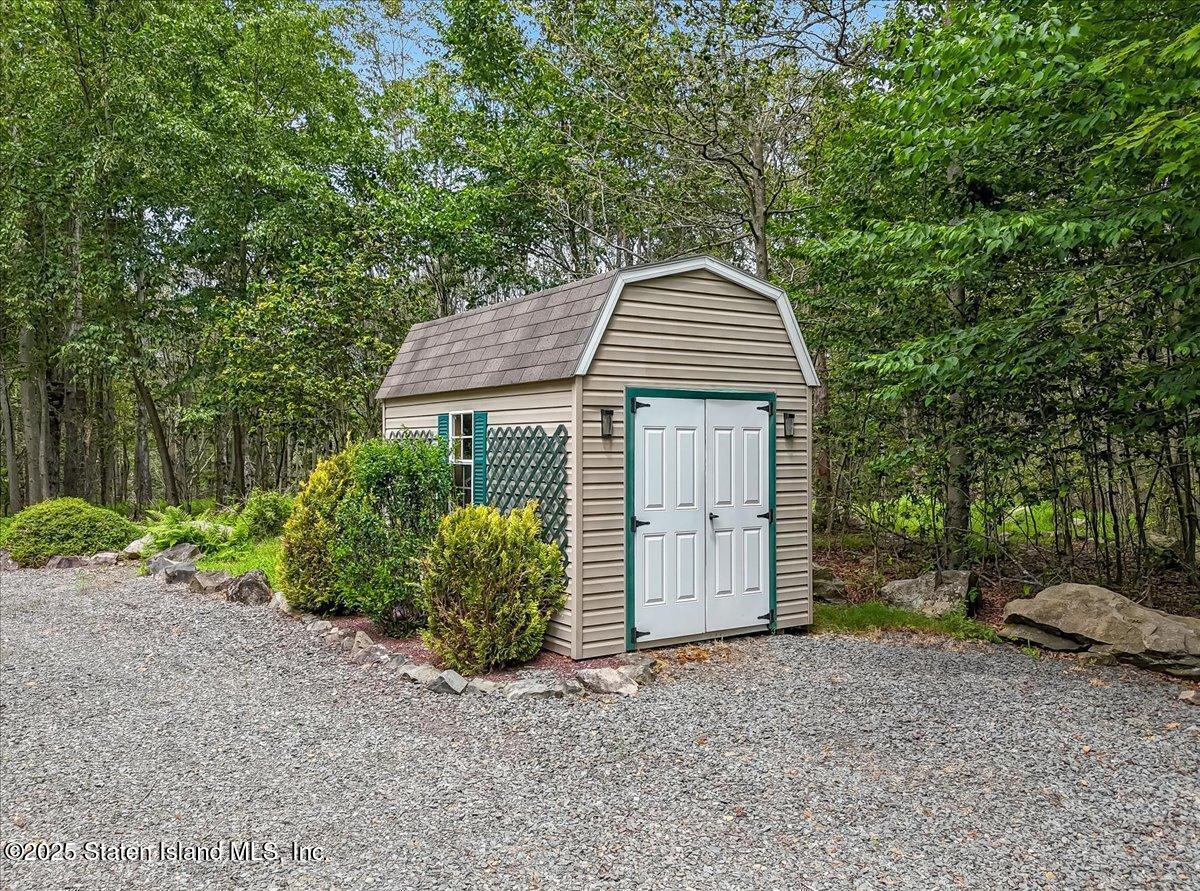 134 Split Rock Road Dingmans Ferry, PA 18328 - Photo 67 of 84 a front view of a house with a yard and garage