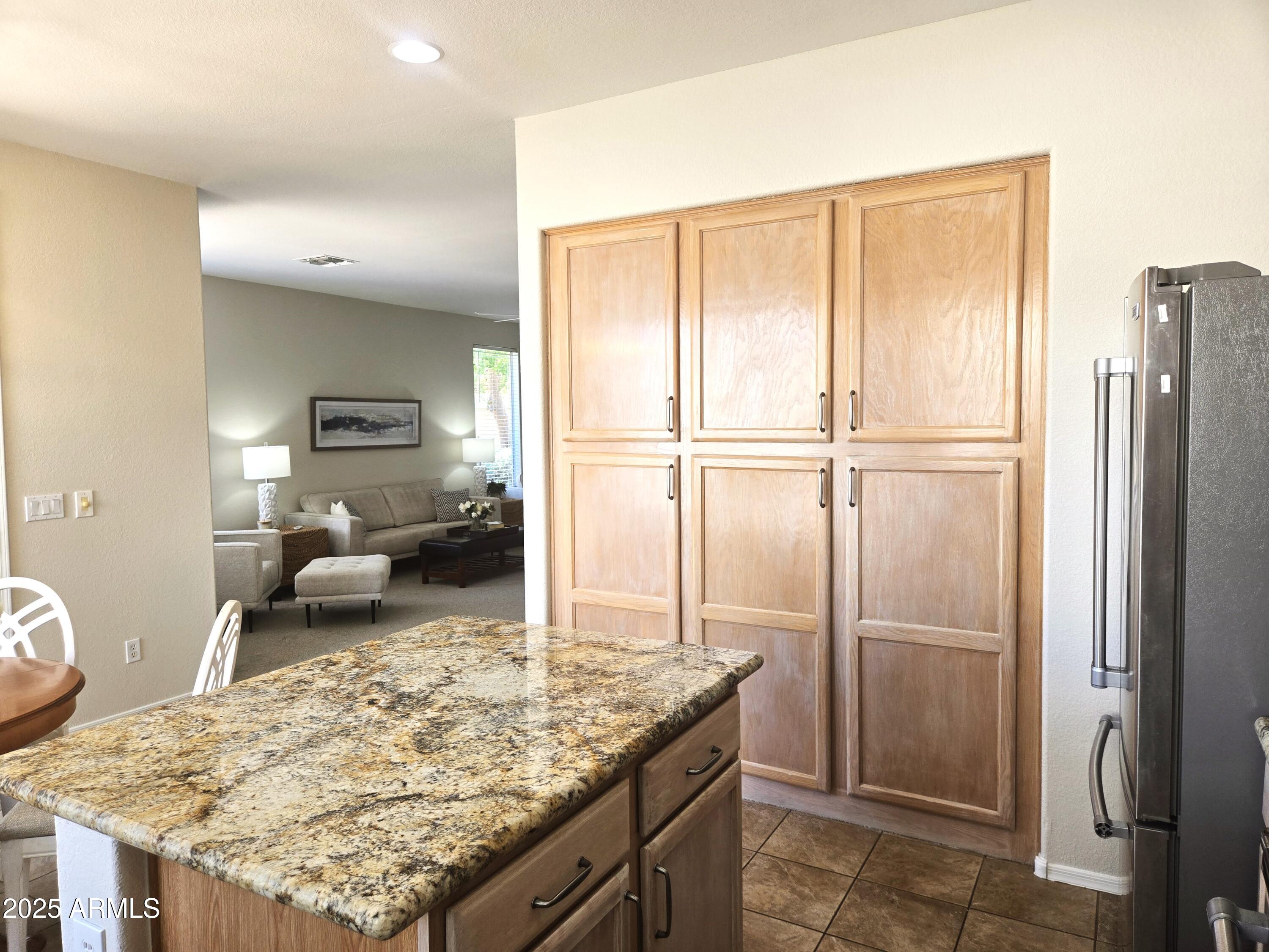 1187 South Hazel Street Gilbert, AZ 85296 - Photo 12 of 50 a kitchen with a refrigerator and a sink